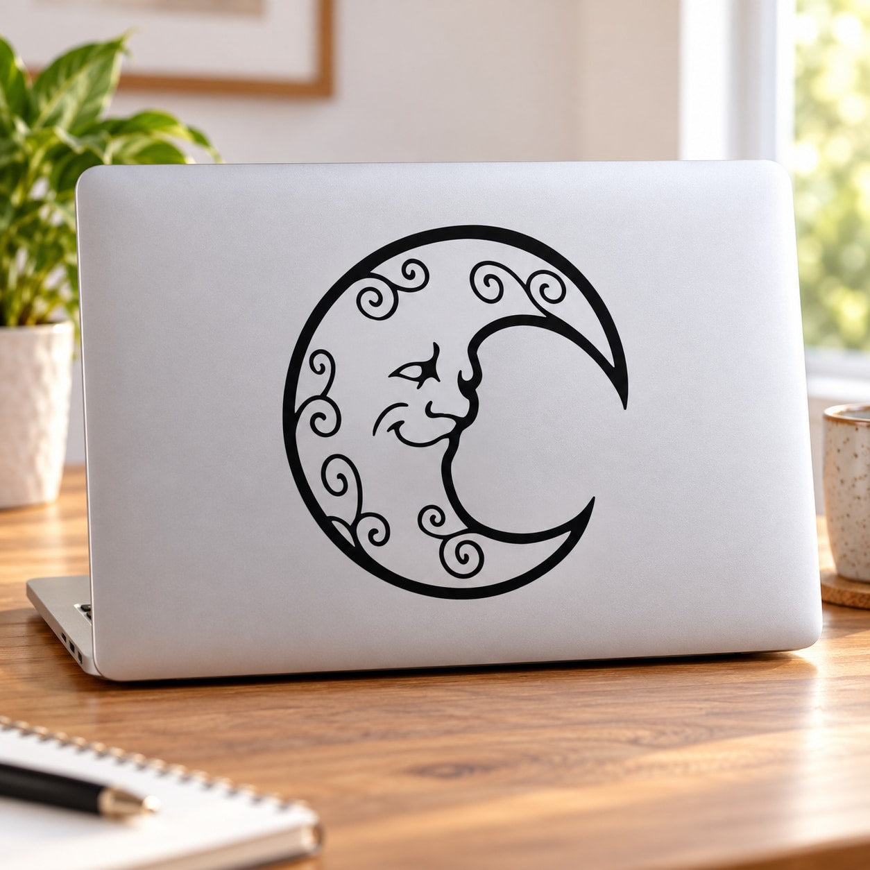Happy moon swirls decal: black crescent with curling swirls on laptop lid