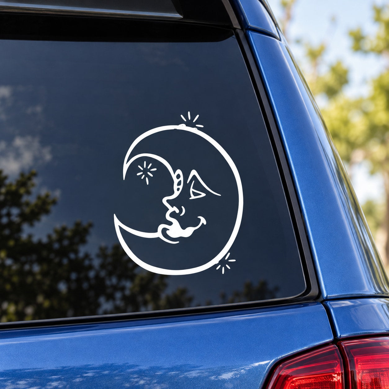 White cat-and-moon decal sticker on dark window