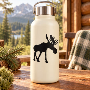 Walking moose silhouette decal in black on a cream bottle