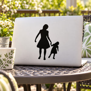 Silhouette decal of mother and daughter holding hands on laptop lid