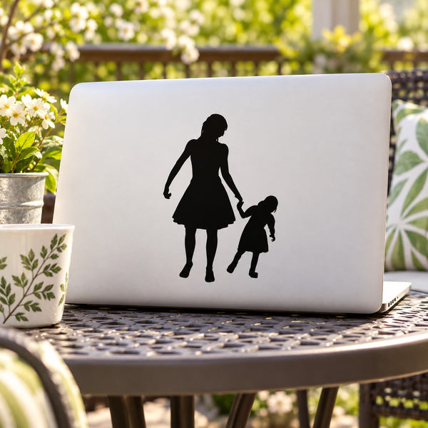 Silhouette decal of mother and daughter holding hands on laptop lid