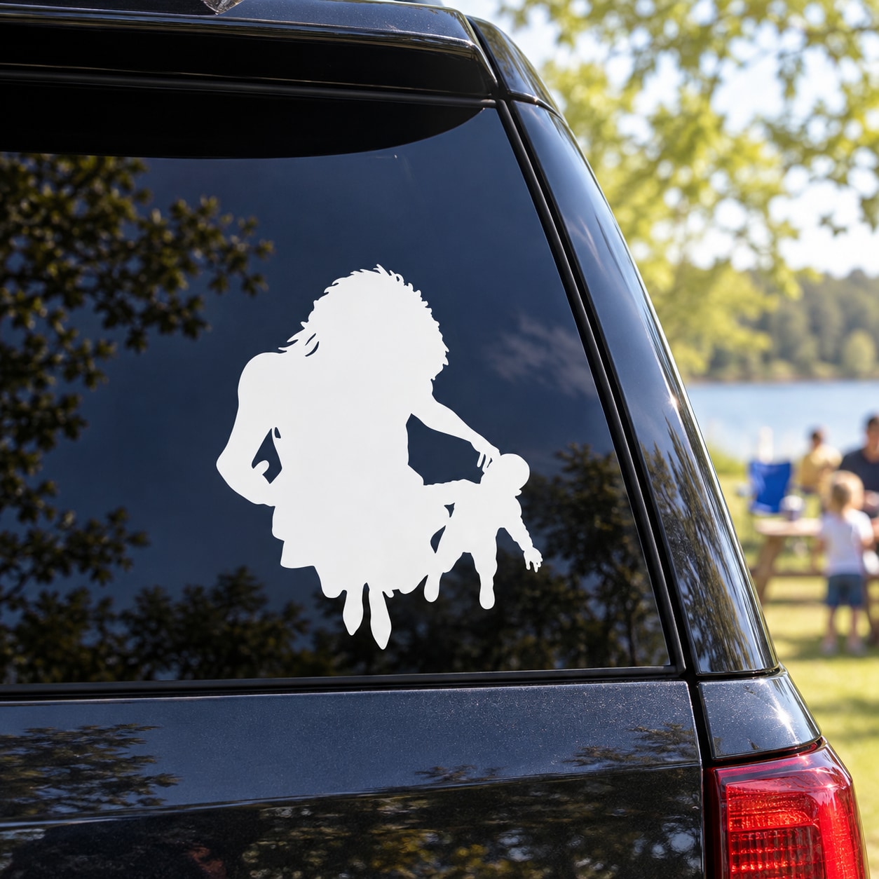 Mother and child silhouette decal with mother holding a small child, white on dark window