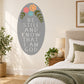 Oval gray quote sticker with floral accents: Be Still And Know I Am God