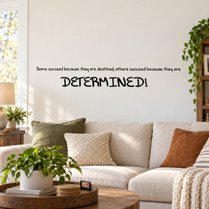 Wall quote mural decal with 'DETERMINED!' in bold black letters on a light wall