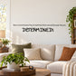 Wall quote mural decal with 'DETERMINED!' in bold black letters on a light wall