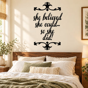 Wall decal with black script quote: "She believed she could... so she did."