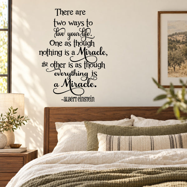 Wall decal with Albert Einstein quote in black script letters on light background