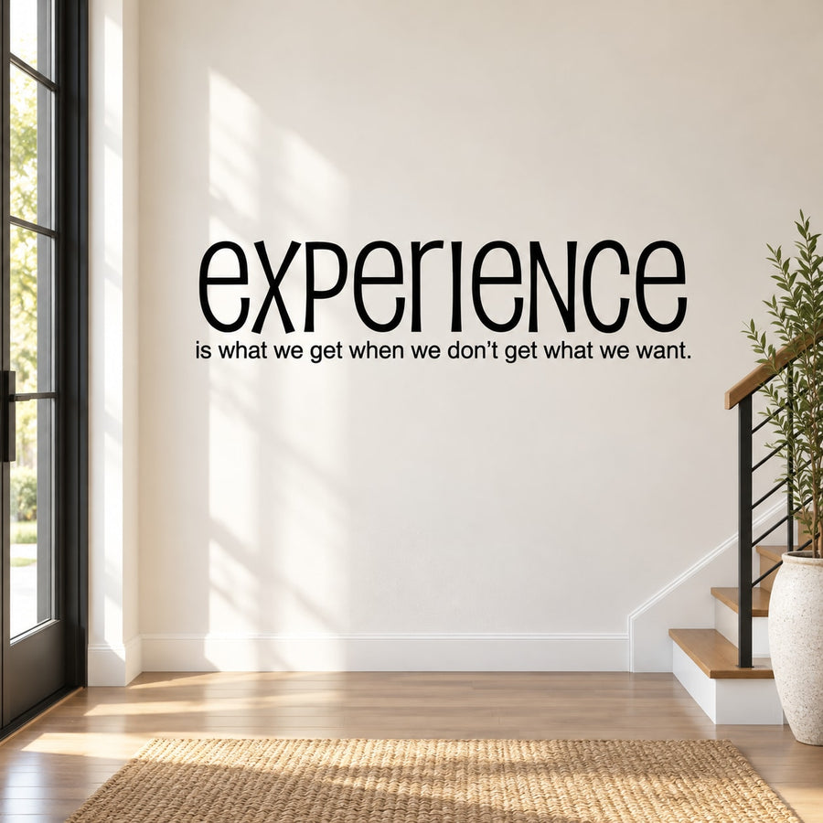 Black quote wall decal: “Experience is what we get when we don’t get what we want”