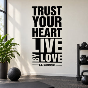 Wall decal with stacked black text: “TRUST YOUR HEART LIVE BY LOVE” and “E.E. Cummings”