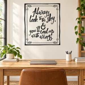 Square wall quote decal with black border and handwritten lettering, decorative corner swirls