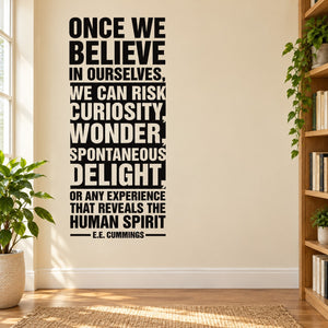 Wall decal with black quote text: “Once we believe… curiosity, wonder, delight.”