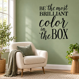 Wall decal with motivational black script text: 'Be the most brilliant color in the box'
