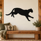 Black mountain lion landing wall decal, silhouette of cat crouching in mid-stride