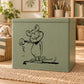 Black line-art mouse decal holding a small object, shown on a green surface