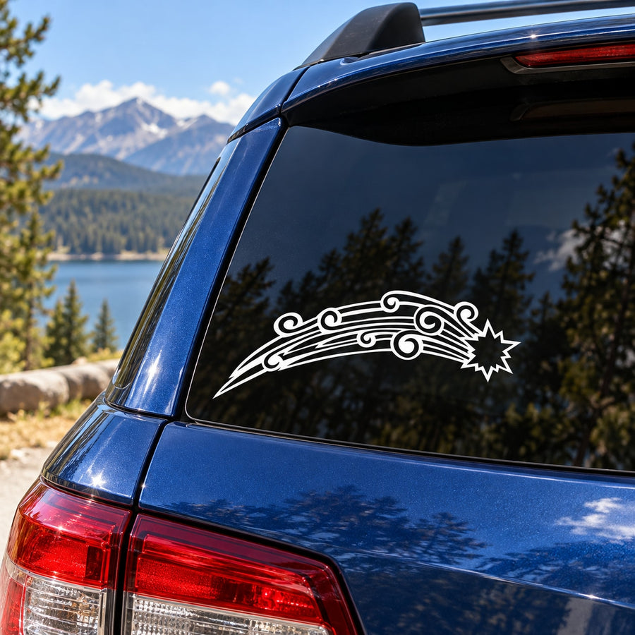 White shooting star decal on dark car rear window