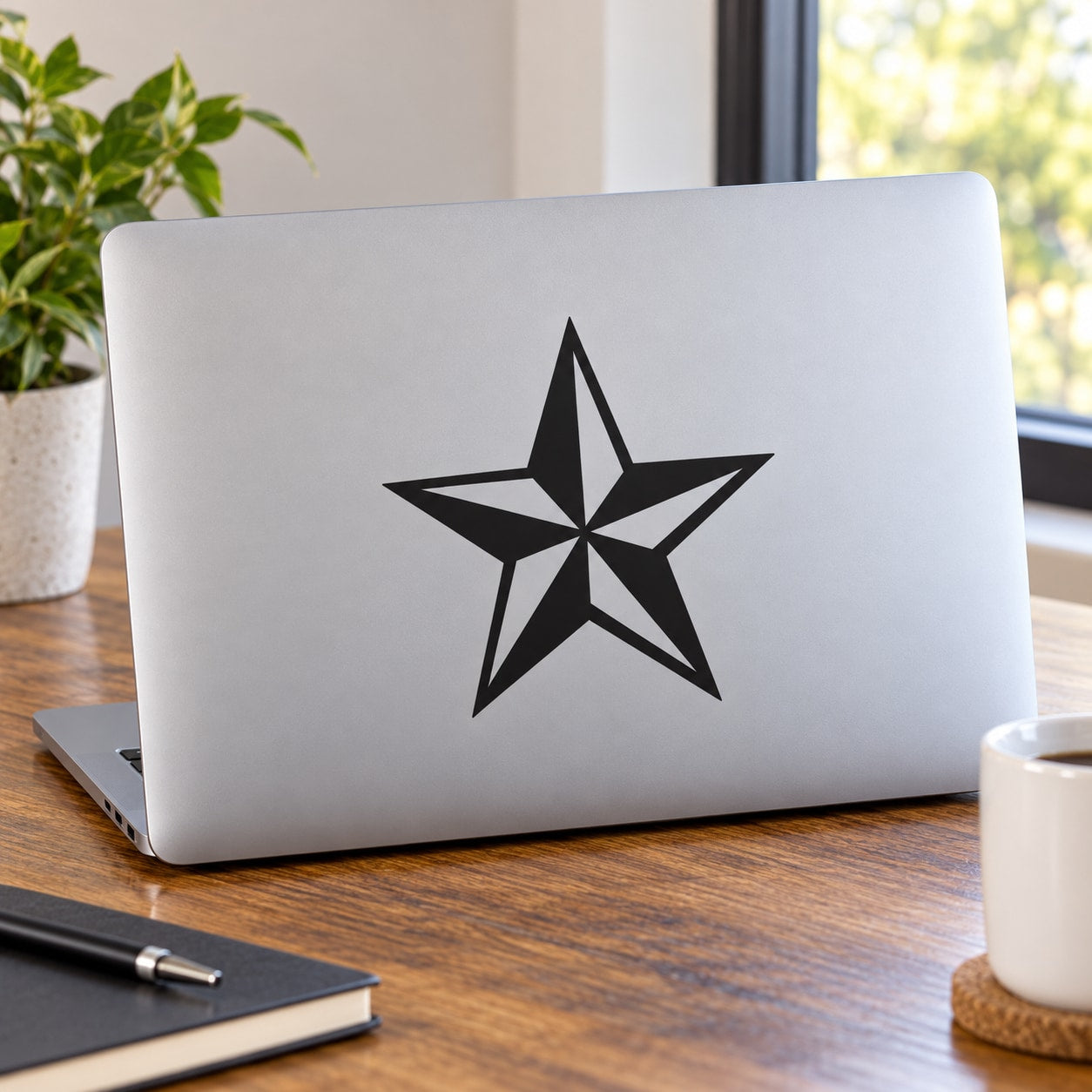 Nautical star decal: black five-point star on a light laptop lid