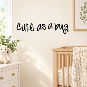 Wall decal with black cursive text reading “Cute as a bug”