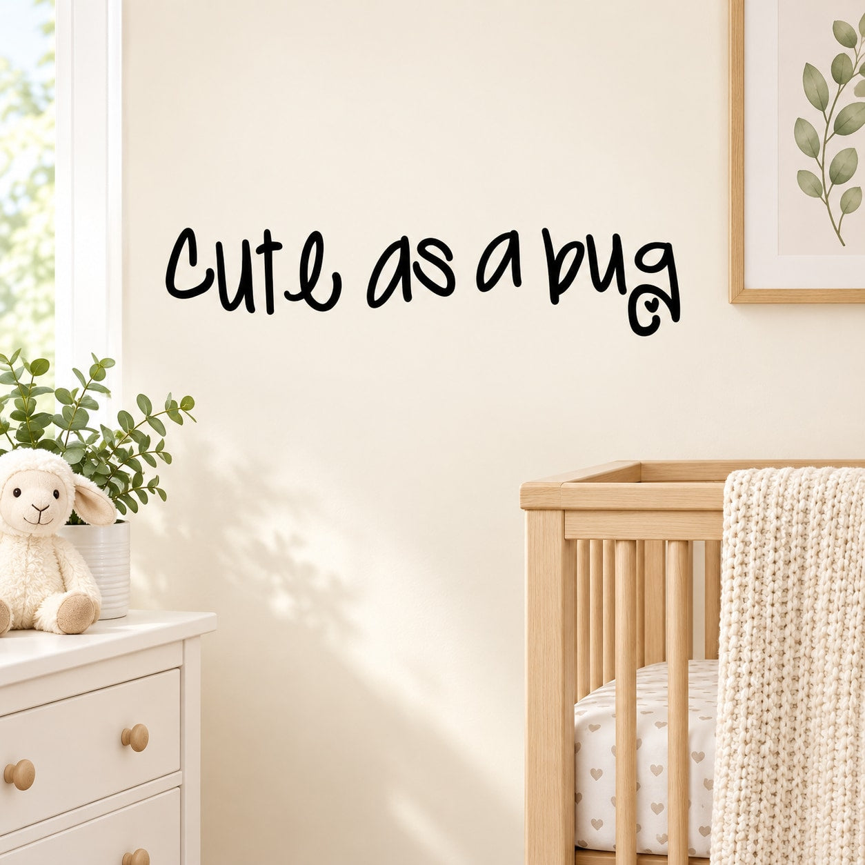 Wall decal with black cursive text reading “Cute as a bug”
