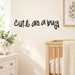 Wall decal with black cursive text reading “Cute as a bug”