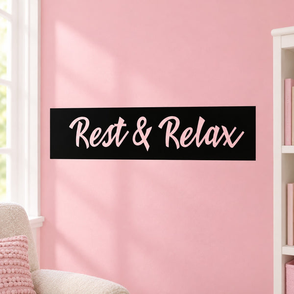 Wall decal with black rectangle and cursive “Rest & Relax” text