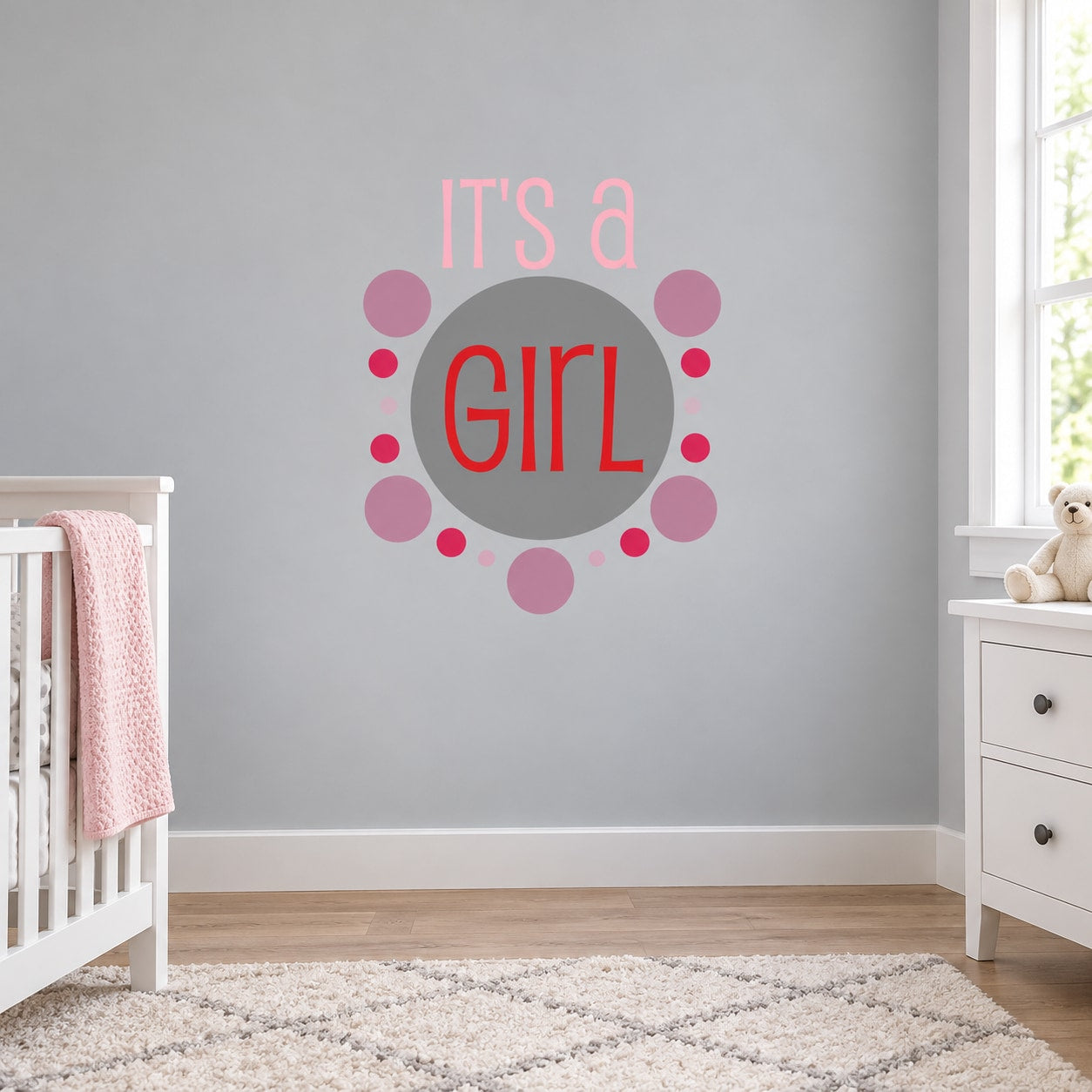 It’s a Girl wall decal with pink text and circular dot design