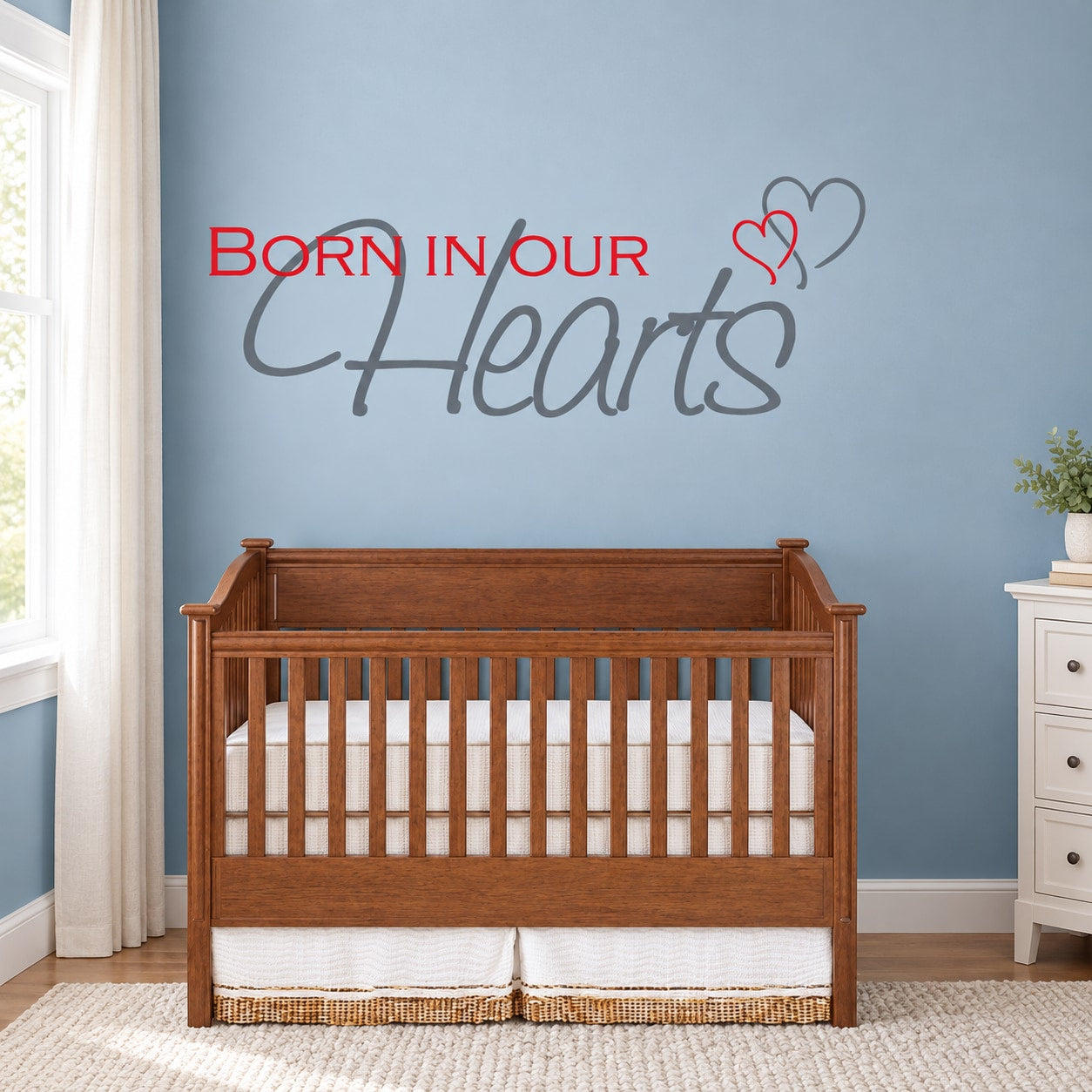 Wall decal with red 'Born in our' text, script 'Hearts', and heart graphic
