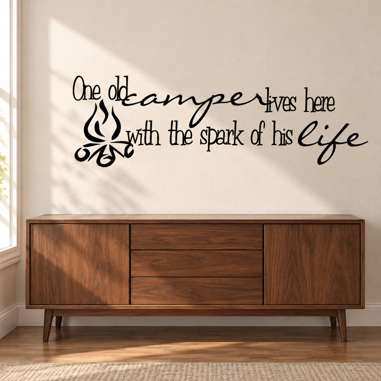 Wall decal with cursive quote and small camper icon in black