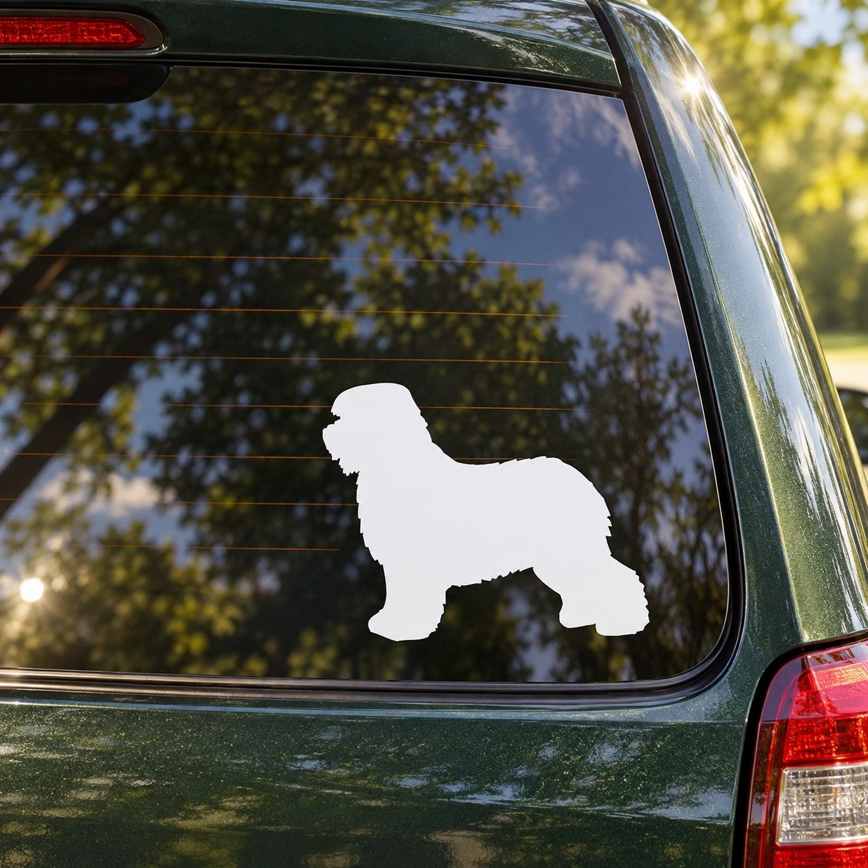 Old English Sheepdog decal silhouette on a car window, white dog shape