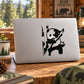 Black-and-white panda hanging from a tree branch wall decal