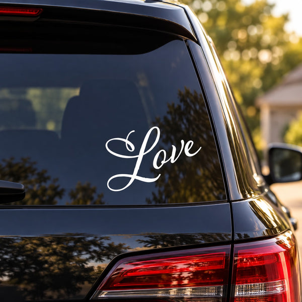 White cursive “Love” decal on car rear window