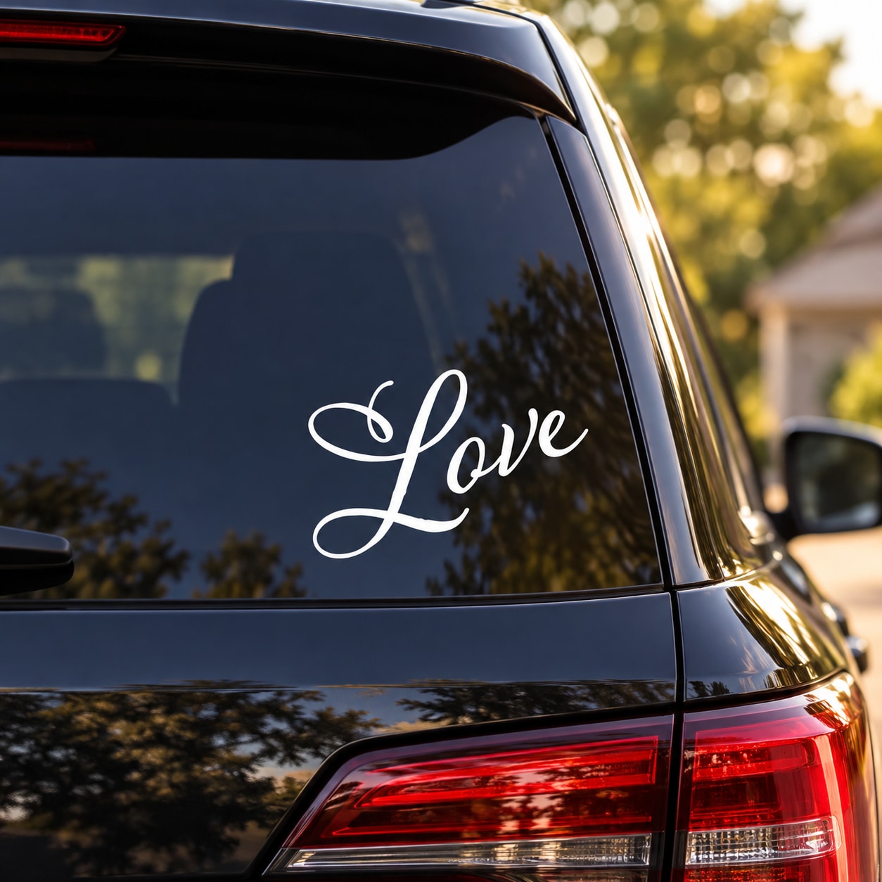 White cursive “Love” decal on car rear window