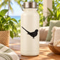 Standing parrot silhouette decal in black on a light-colored bottle