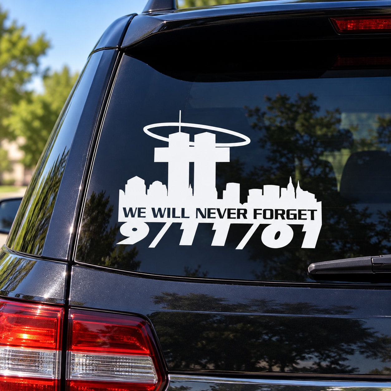 Car window 9/11 memorial decal with airplane icon and 'WE WILL NEVER FORGET' text