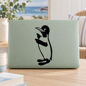 Black penguin decal sticker with bowtie on light green rectangular surface