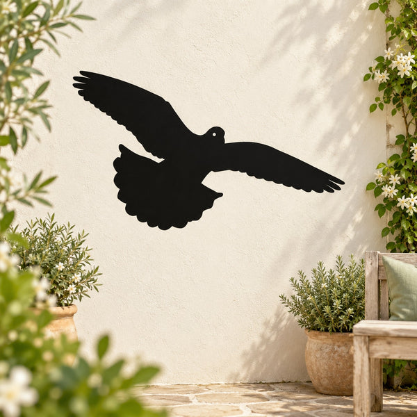Black flying pigeon wall decal with spread wings and upward swoop