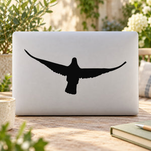 Black flapping pigeon silhouette decal on a light surface
