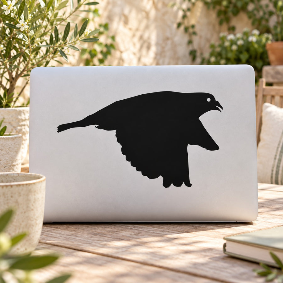 Gliding pigeon decal featuring a black bird silhouette in midflight on a light surface