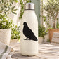Black standing pigeon decal on white insulated bottle