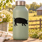 Pig silhouette decal, black on a pale bottle