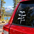 White plant sapling decal on car rear window glass, small branch and leaves.