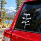 White plant sapling decal on car rear window glass, small branch and leaves.