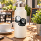 White bottle with black-and-white billiard 8 ball and solid white ball sticker