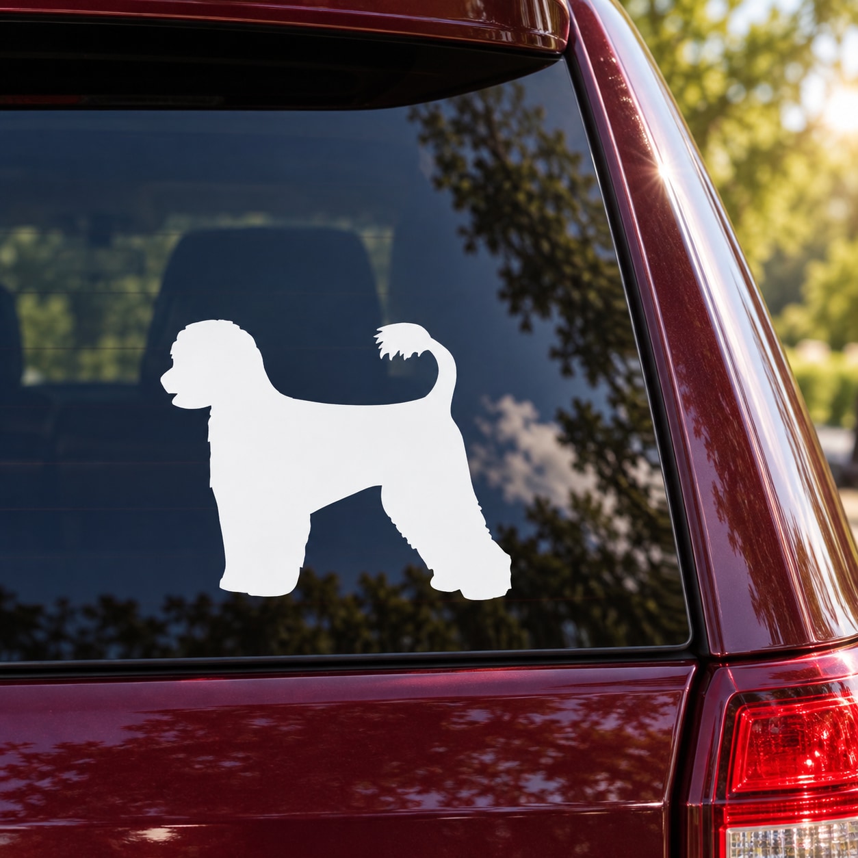White Portuguese water dog silhouette decal on car window