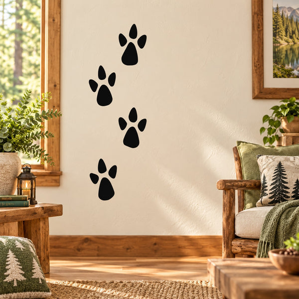 Black walking animal track decal with four paw prints on a wall