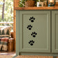 Walking cat track decal with four black paw prints on a light door panel