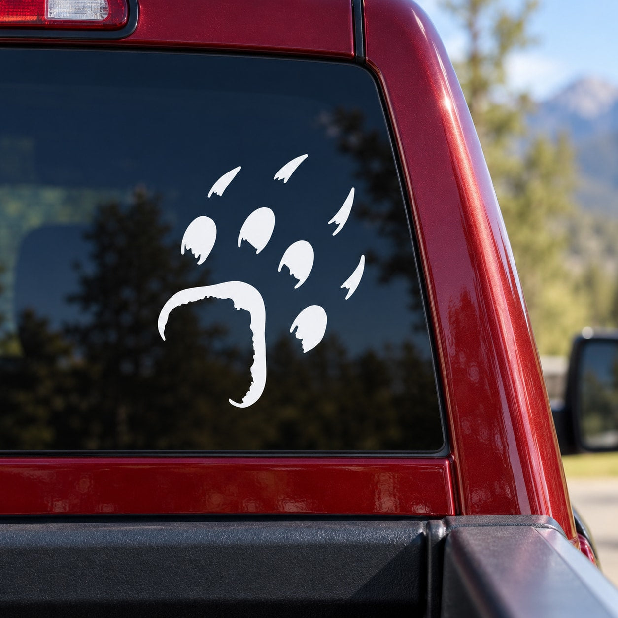 White bear paw print decal on car window glass