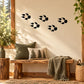 Black fox paw track decals with five paw prints on light beige surface