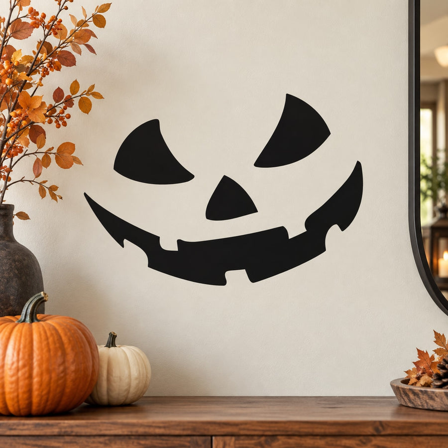Black pumpkin face decal with jack-o'-lantern eyes and jagged grin.