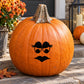 Orange pumpkin decal with black witch face: arched eyes and frown mouth.