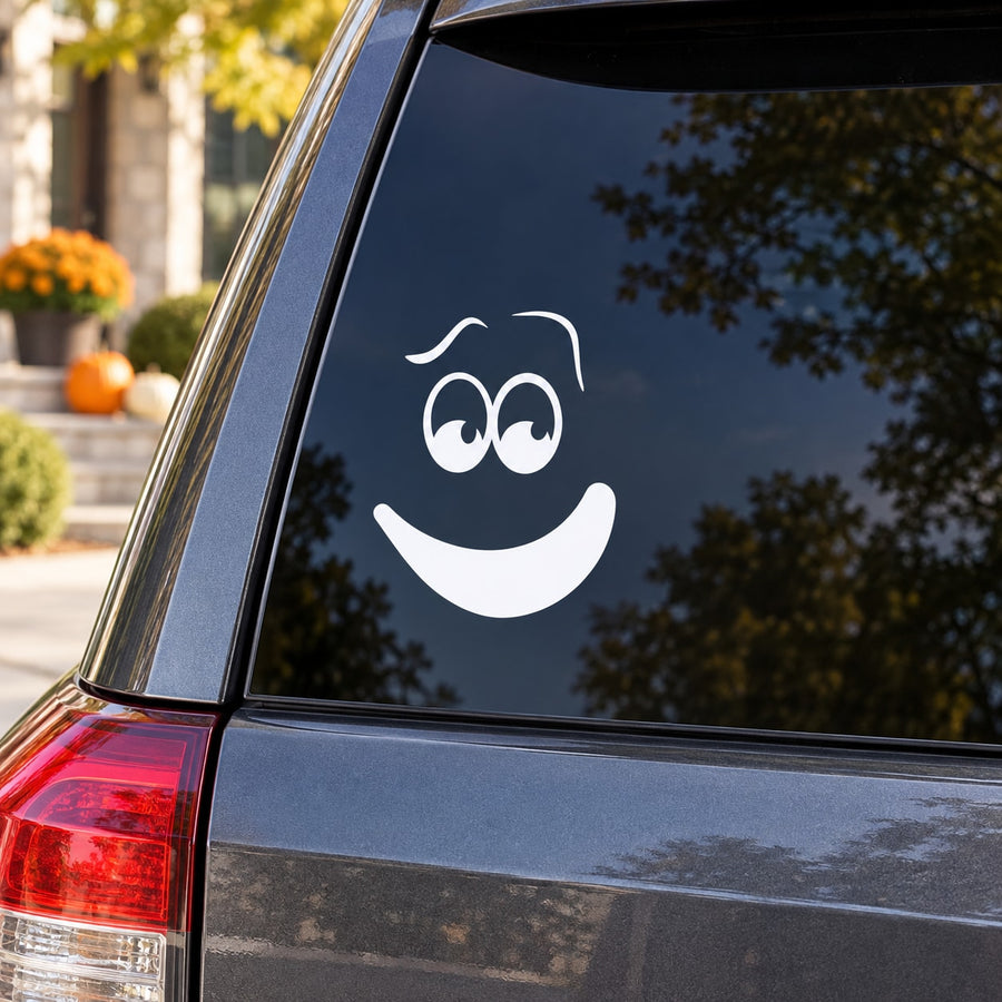 Awkward pumpkin face decal with smiling mouth and wide eyes on car window